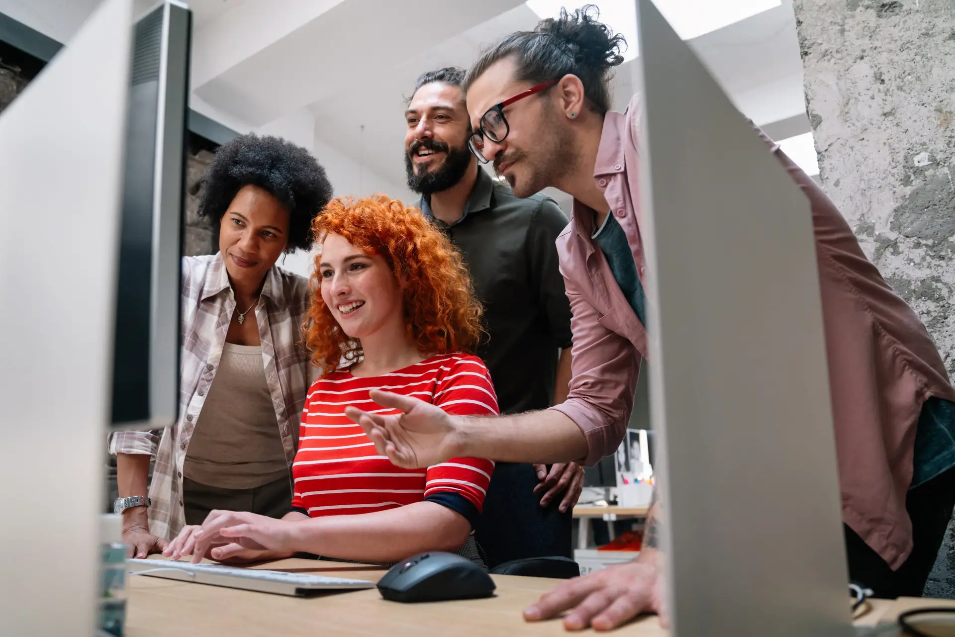 Smiling diverse colleagues gather in boardroom